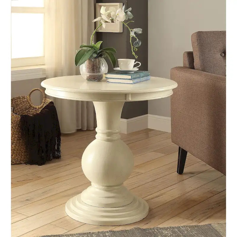 Table piédestal ronde en bois blanc vieilli