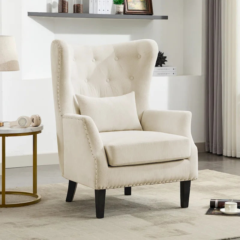 Fauteuil à oreilles en velours côtelé et clous tapissiers classiques