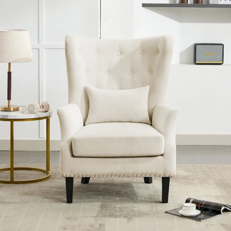 Fauteuil à oreilles en velours côtelé et clous tapissiers classiques